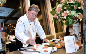 Chef Peter Kelly plating a dish at Feeding Westchester's An Evening in Good Taste Event Best Fall Benefits